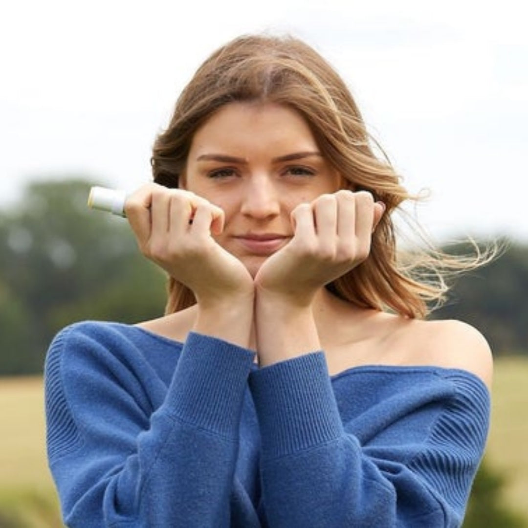 woman smelling wrists after applying balm