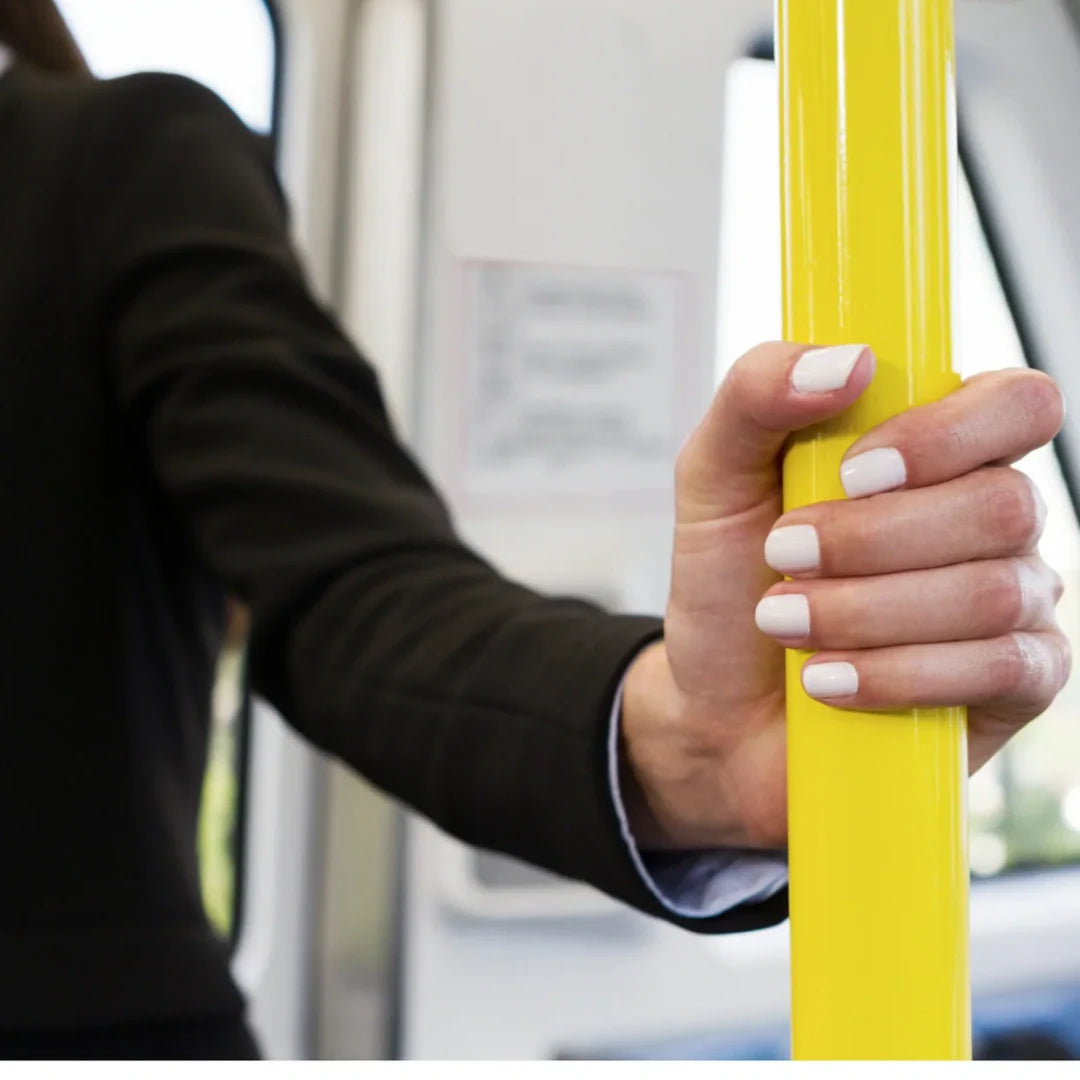 woman holding bar in a bus