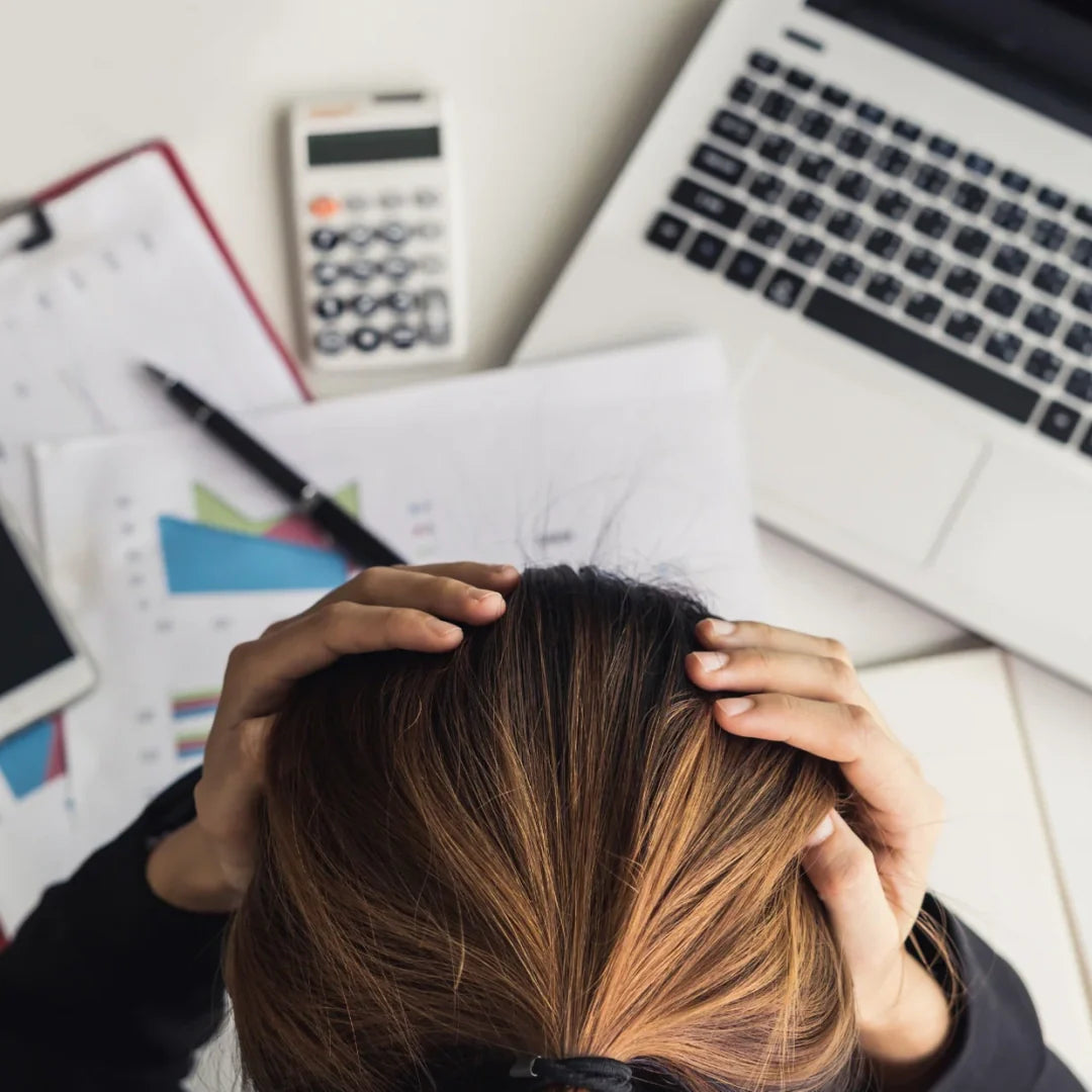 woman stressing on her desk