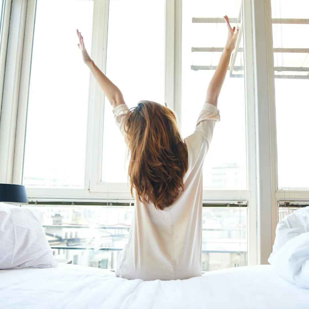 woman waking up and stretching