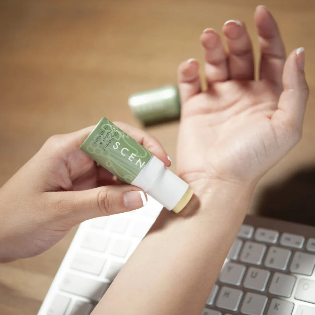 person applying aromatherapy balm on the wrist