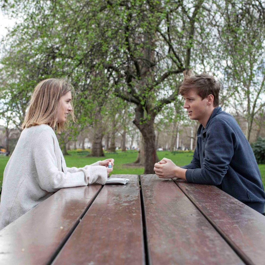 couple talking on a table outside
