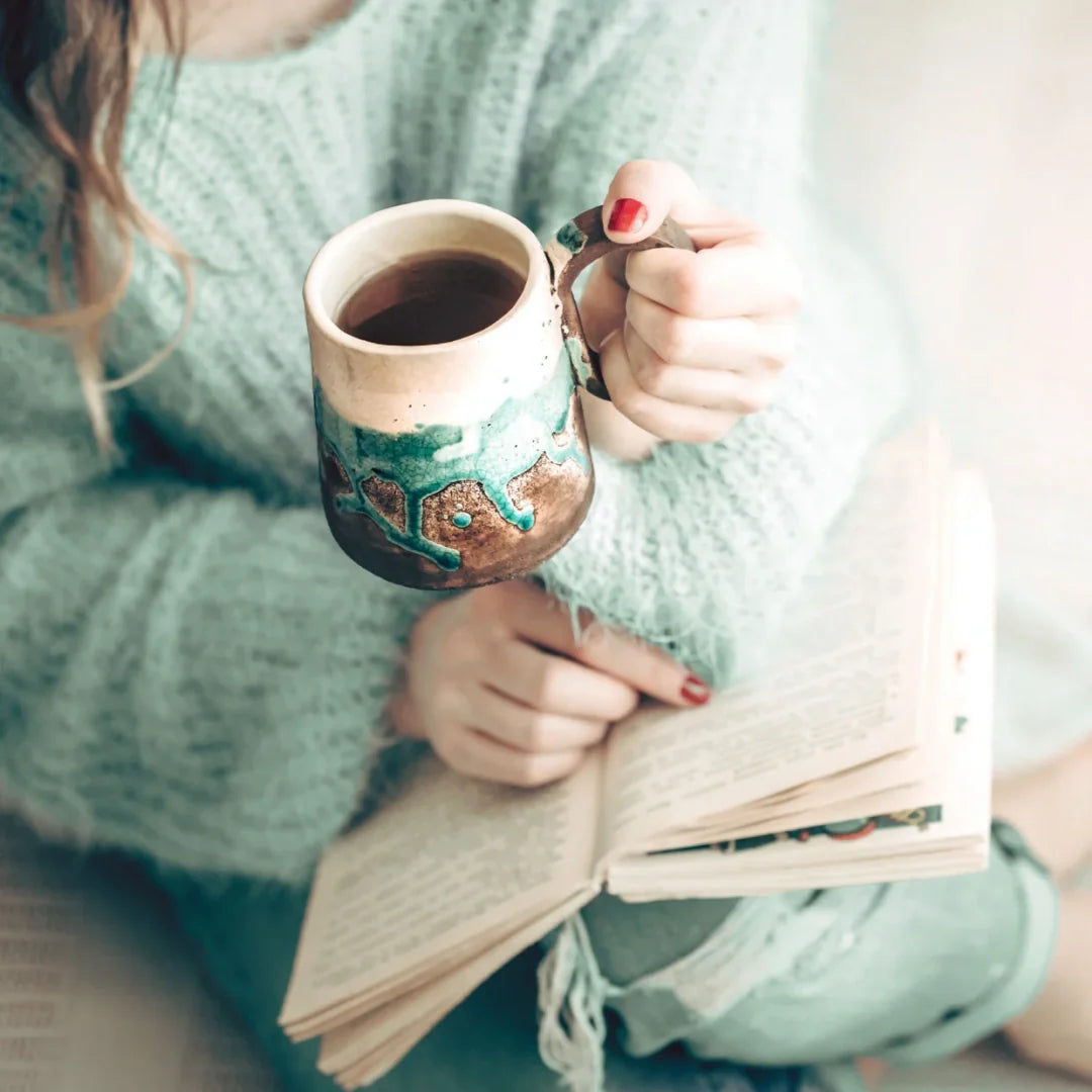woman reading and drinking coffee
