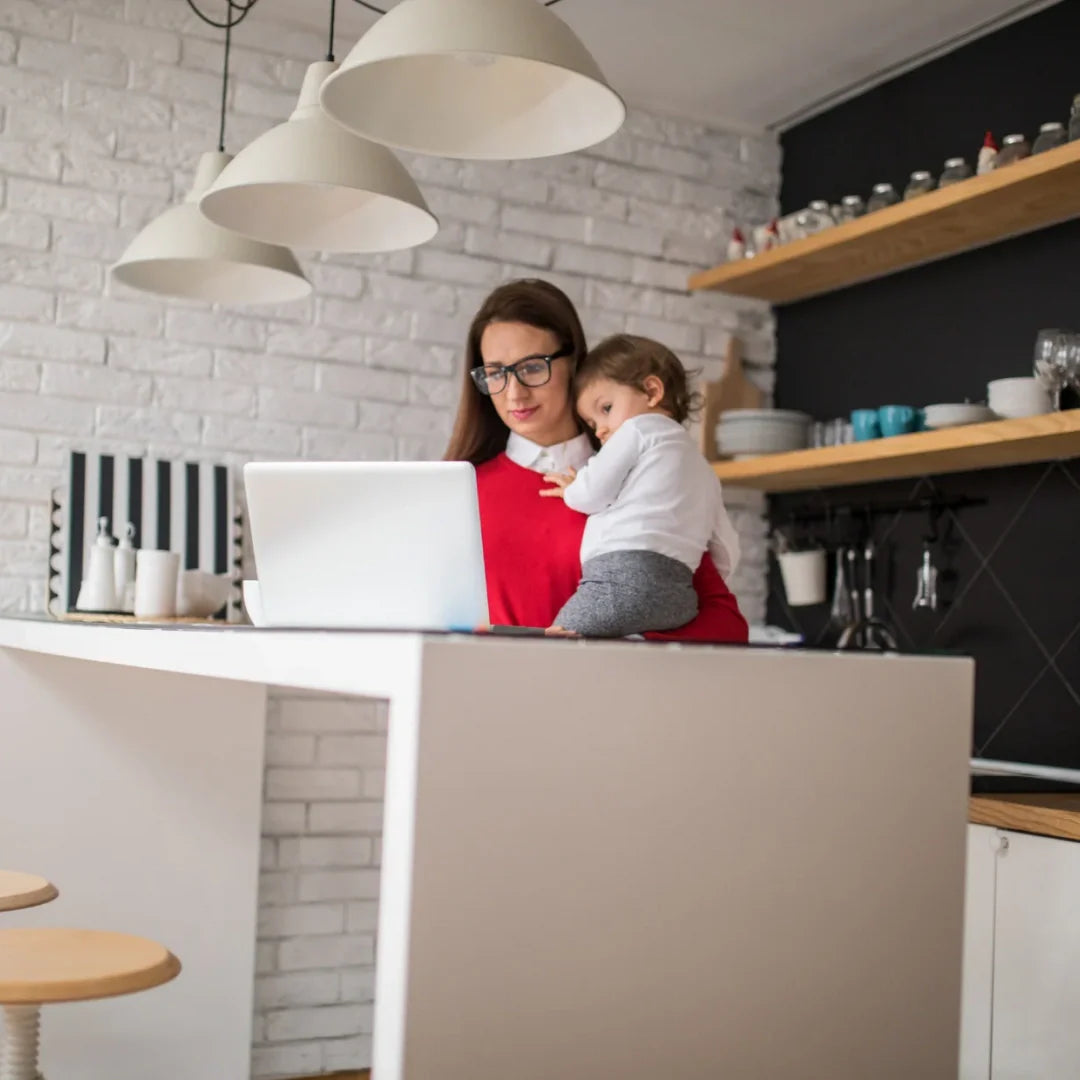 woman carrying her kid while working
