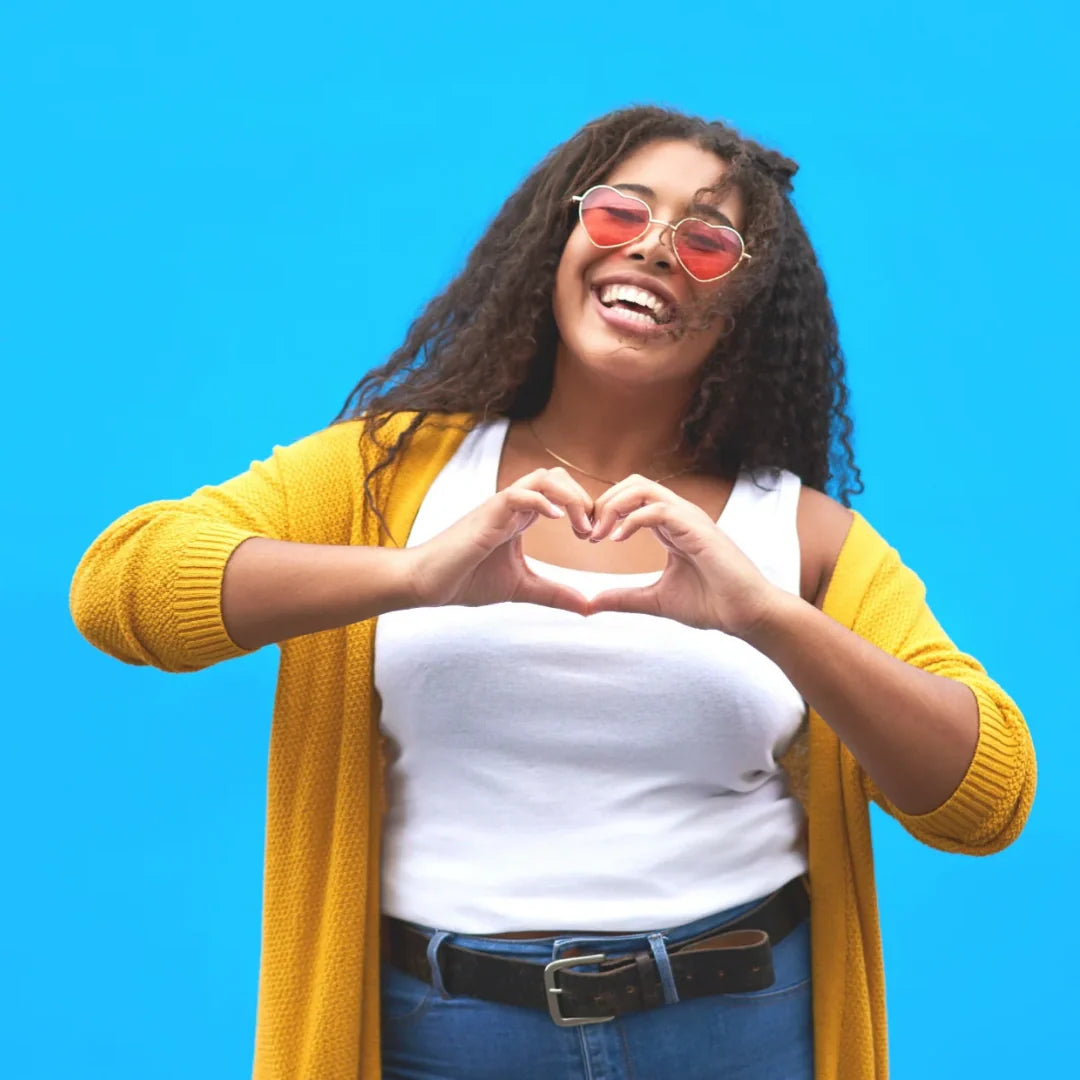 woman making a heart shape with her hands