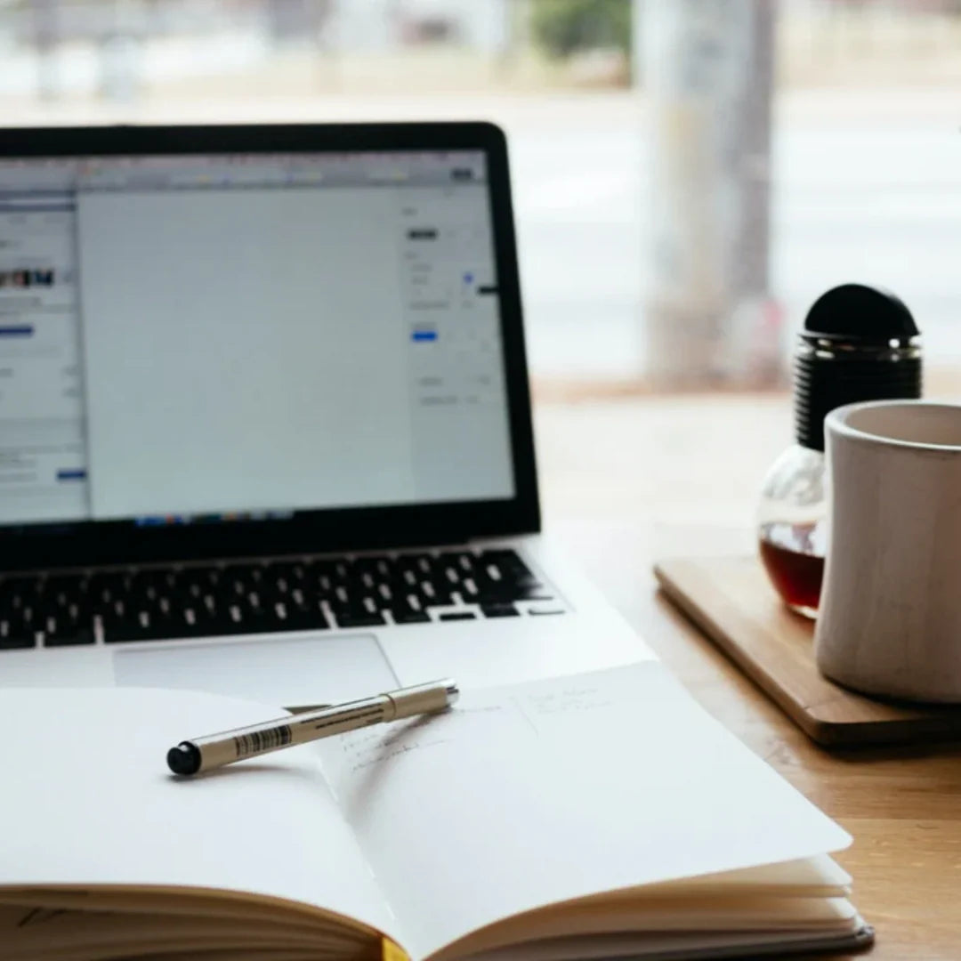 laptop, coffee and notebook on desk