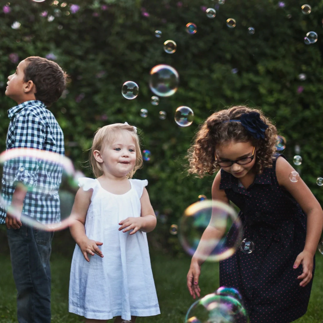 children playing with bubbles