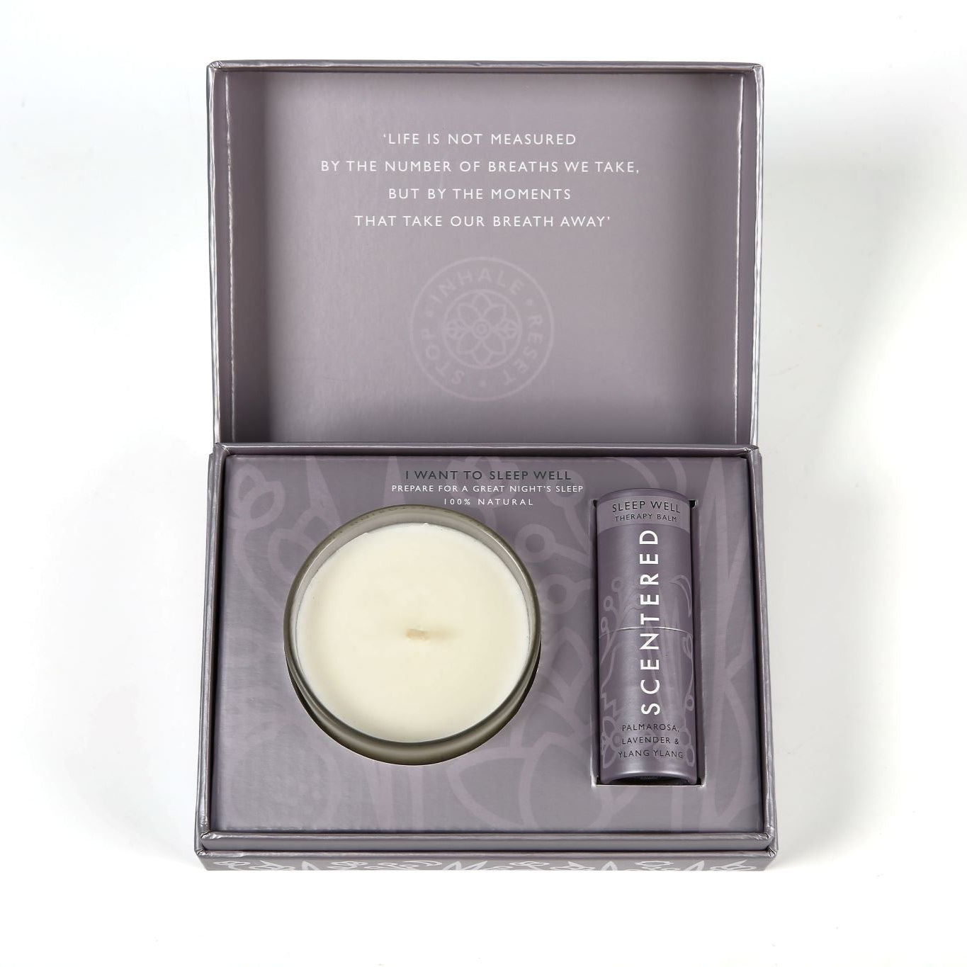 a sleep well balm and a candle packed in a gift box