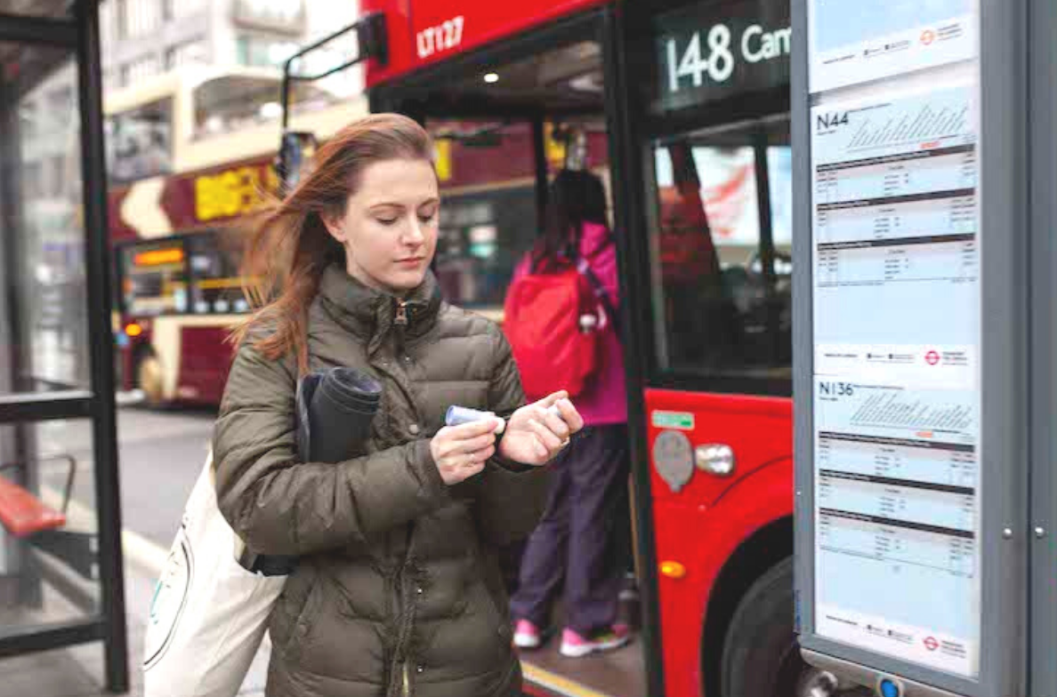 woman applying aromatherapy balm in the street