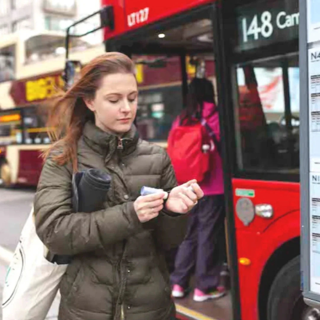 woman applying aromatherapy balm in the street