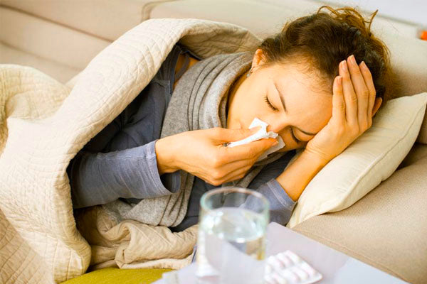 woman with a cold blowing her nose
