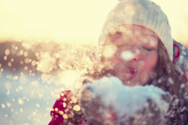 woman blowing snow