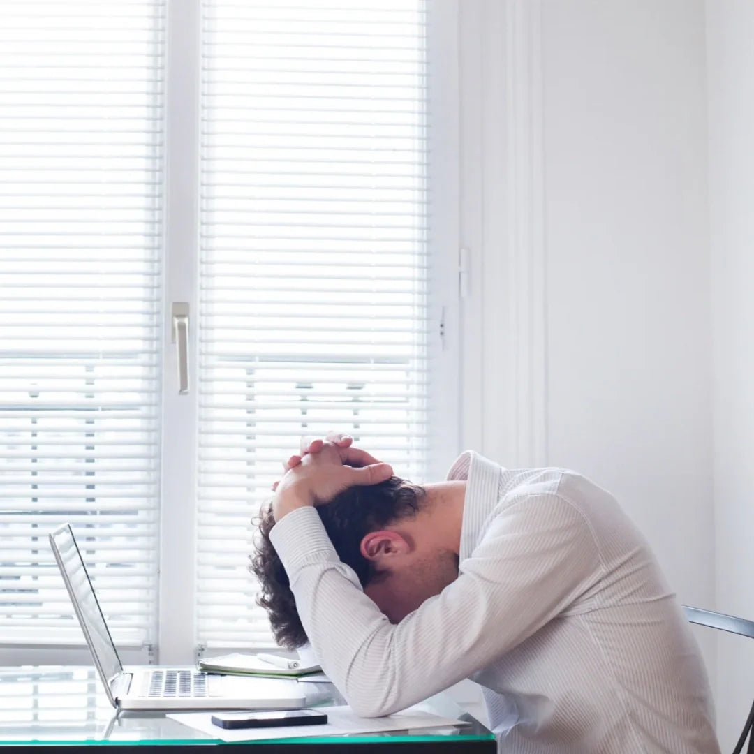man stressing out in front of laptop