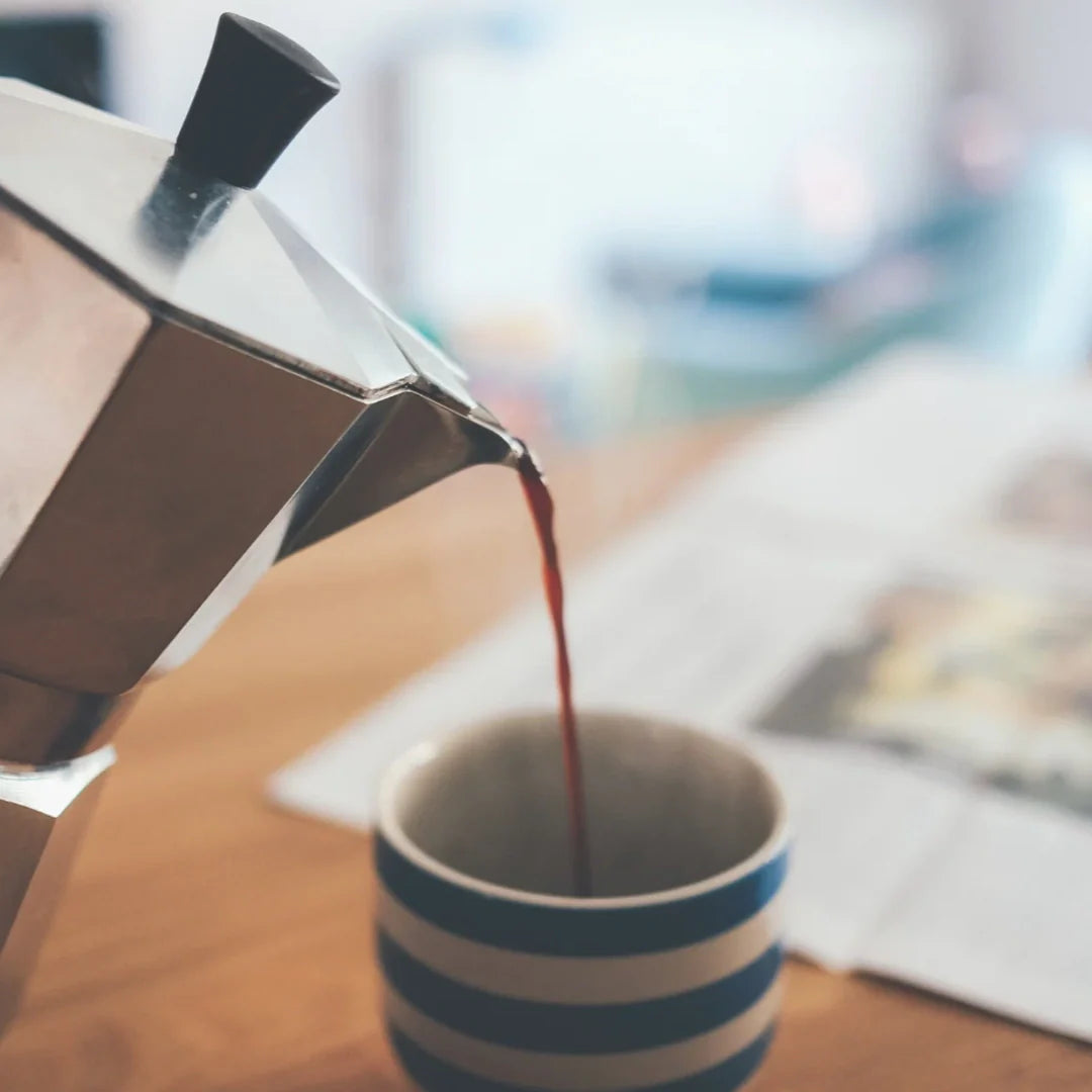 Italian coffee maker pouring on a cup