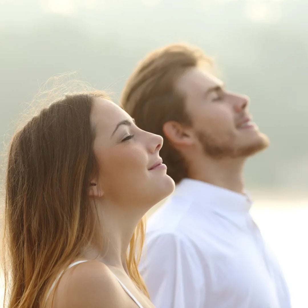 man and woman receiving the sun and smiling