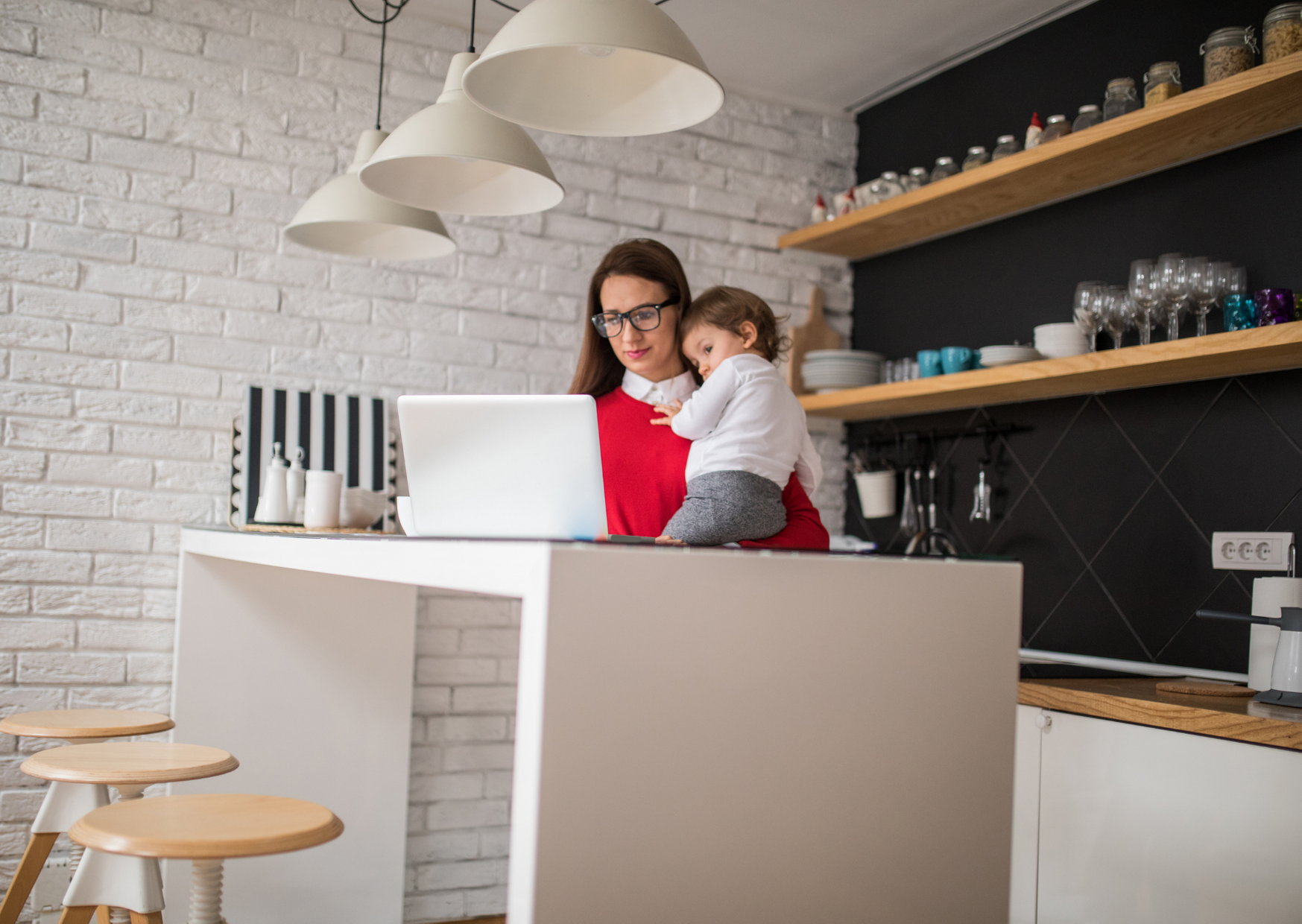 woman carrying her kid while working