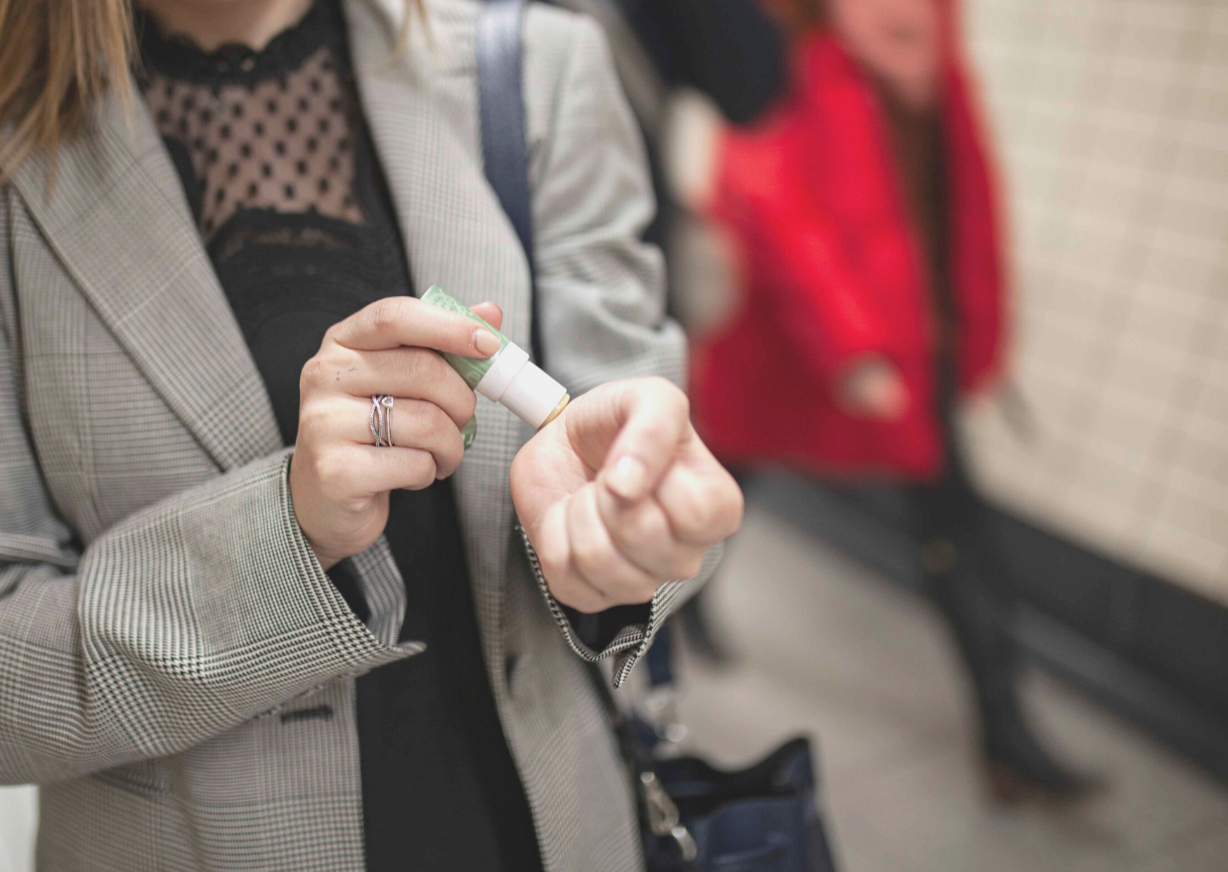 woman applying balm on her wrist