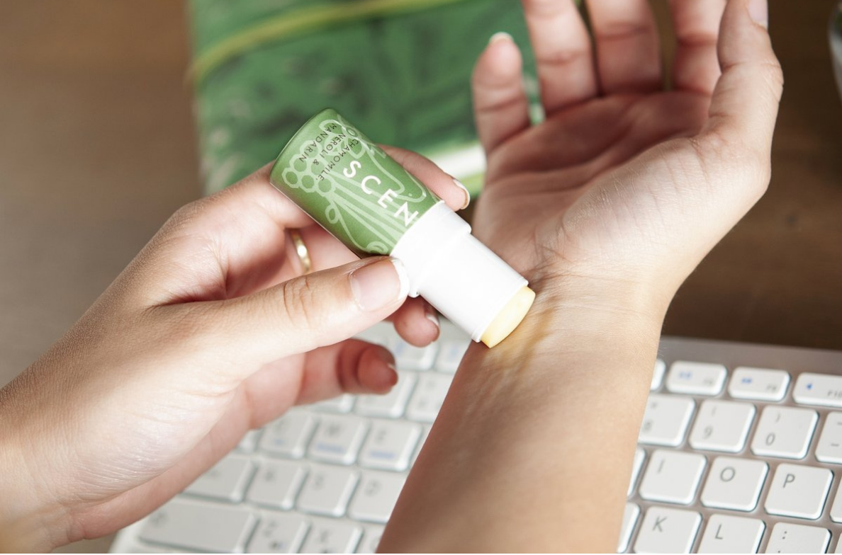 person applying aromatherapy balm on the wrist