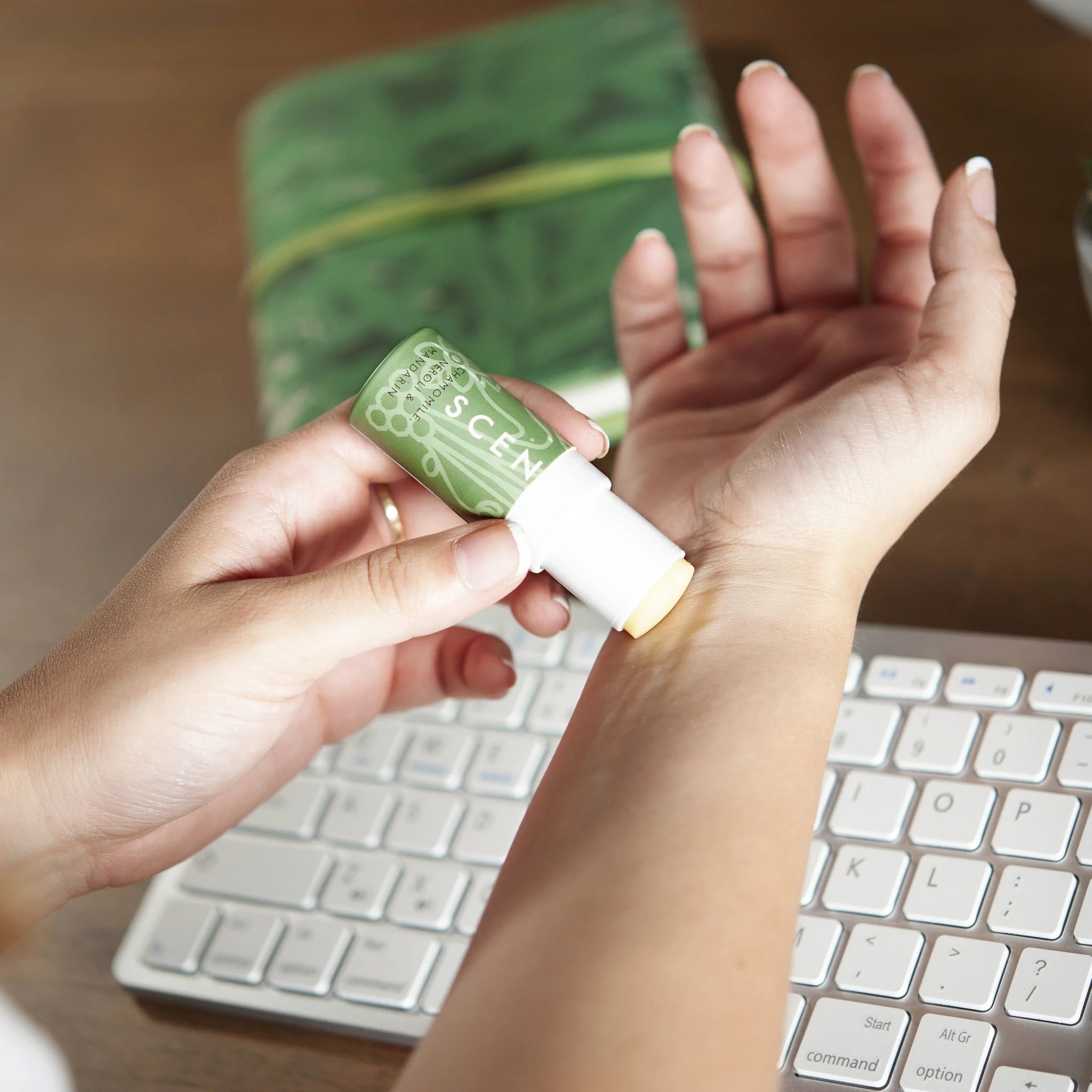 person applying aromatherapy balm in the office