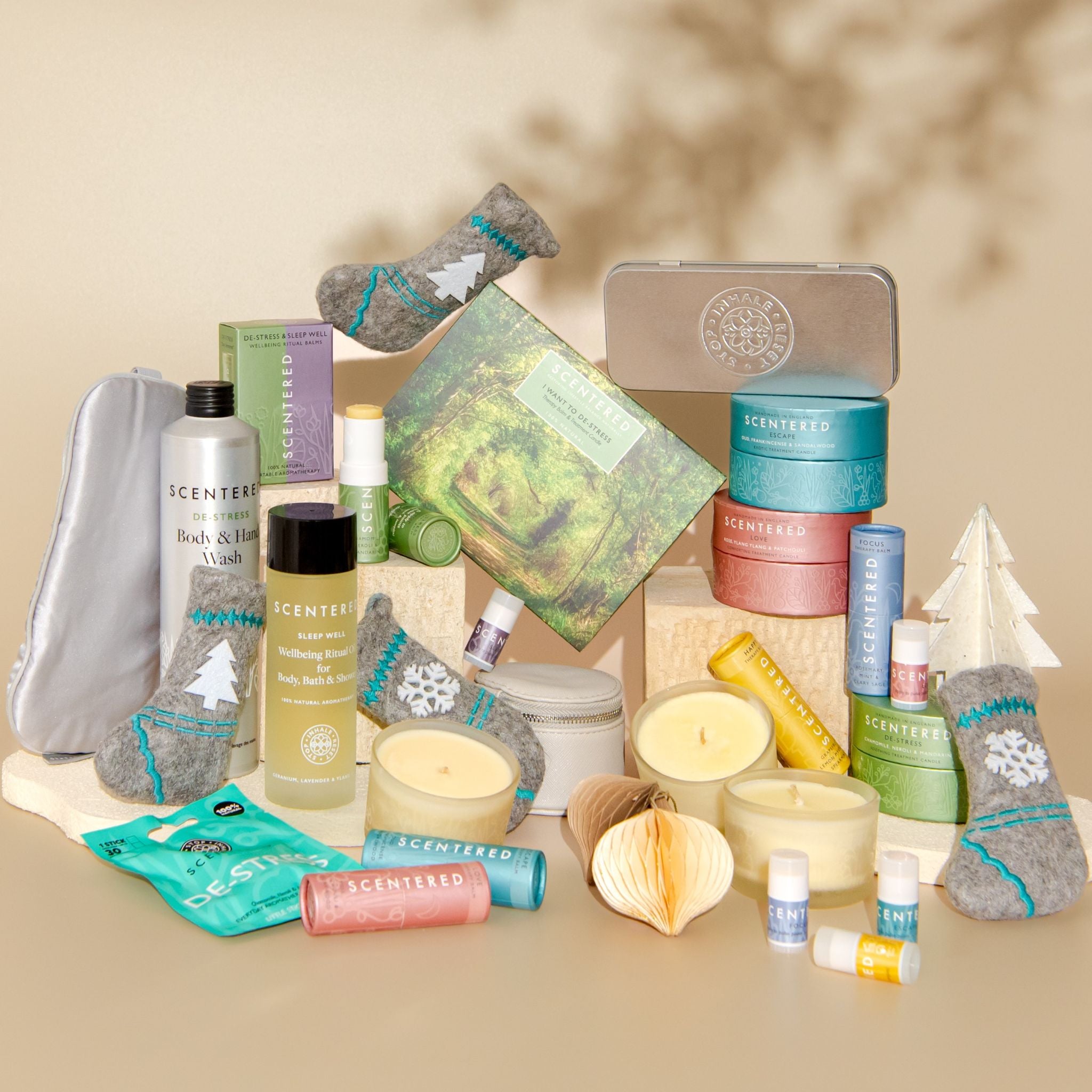 Collection of Scentered products including candles, bottles, and packaging on a neutral background