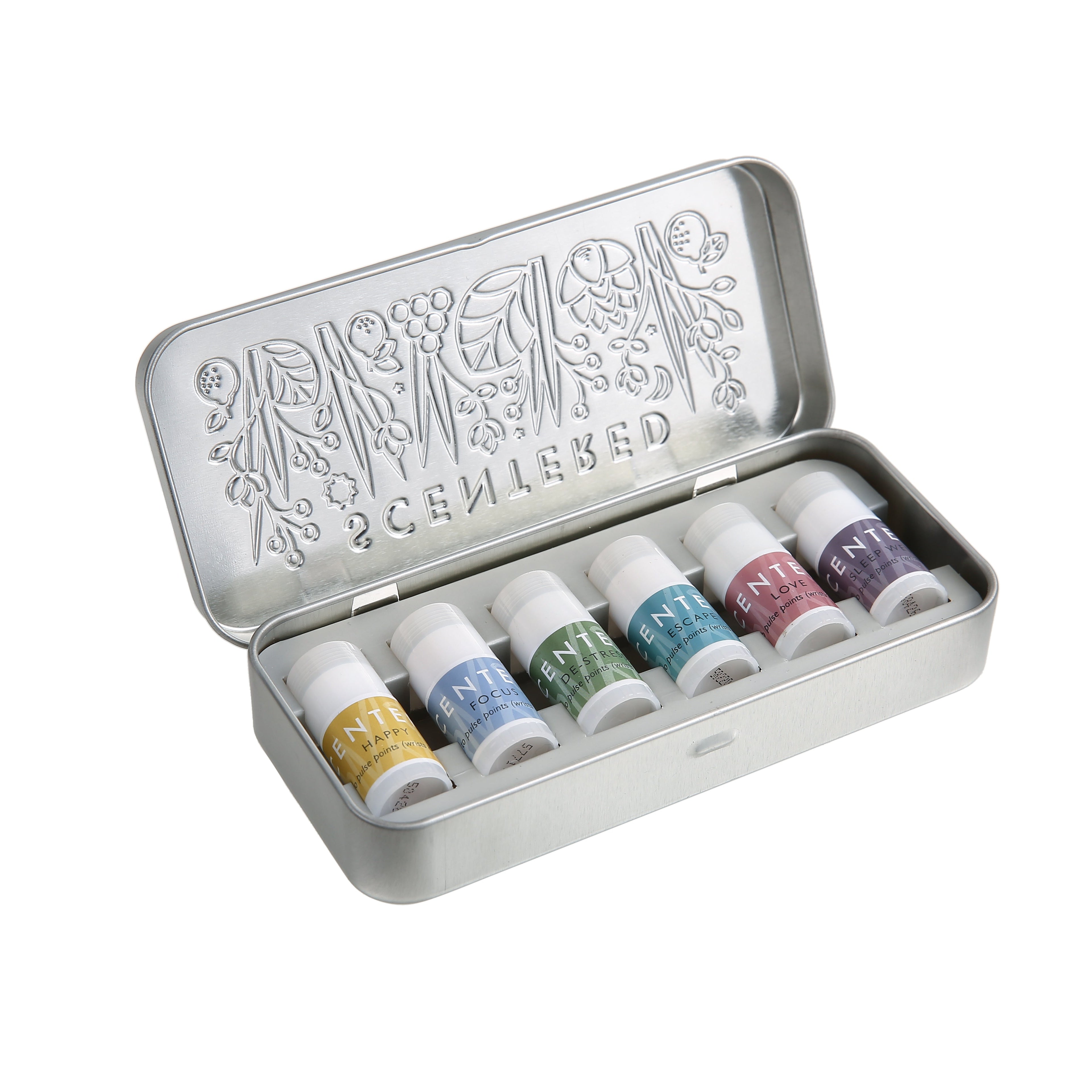 Set of mini balms with different smell inside a silver metal tin on a white background