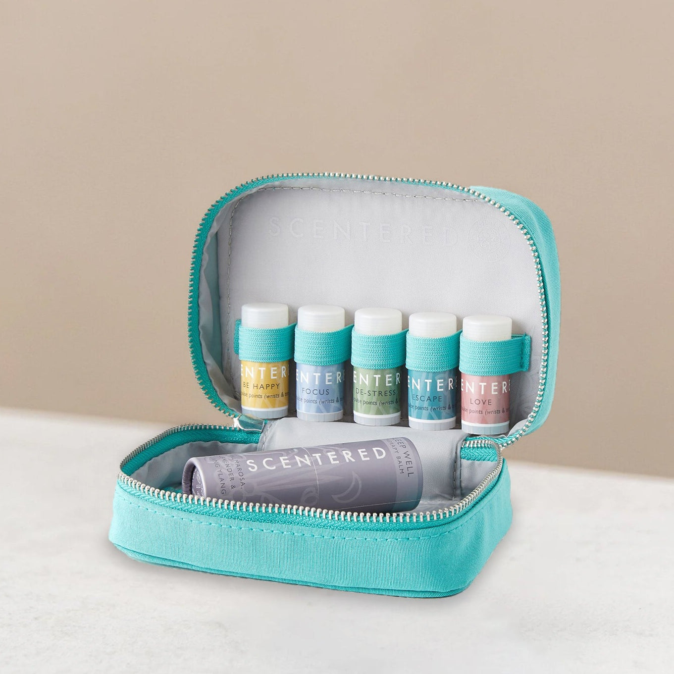 Set of scented balms in a teal travel case 