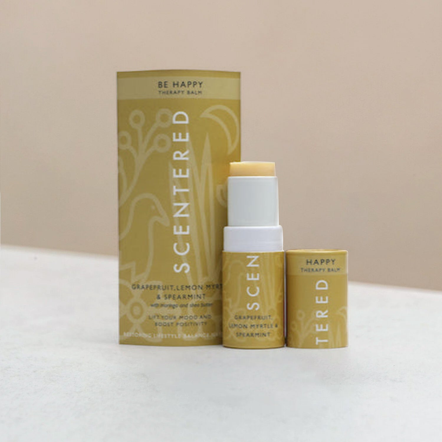 Happy aromatherapy balm with package on a warming background.