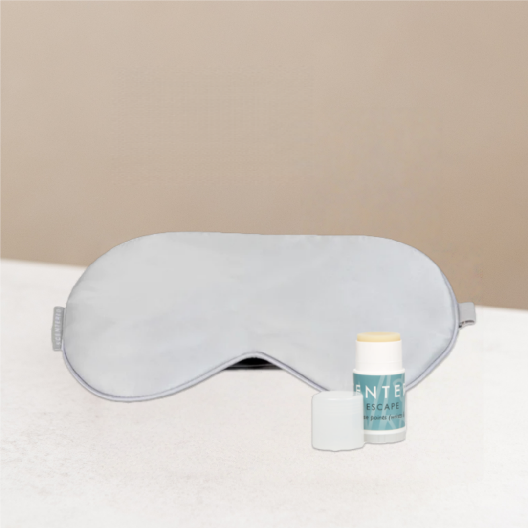 Silver sleep mask and mini balm on a warming background