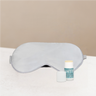 Silver sleep mask and mini balm on a warming background