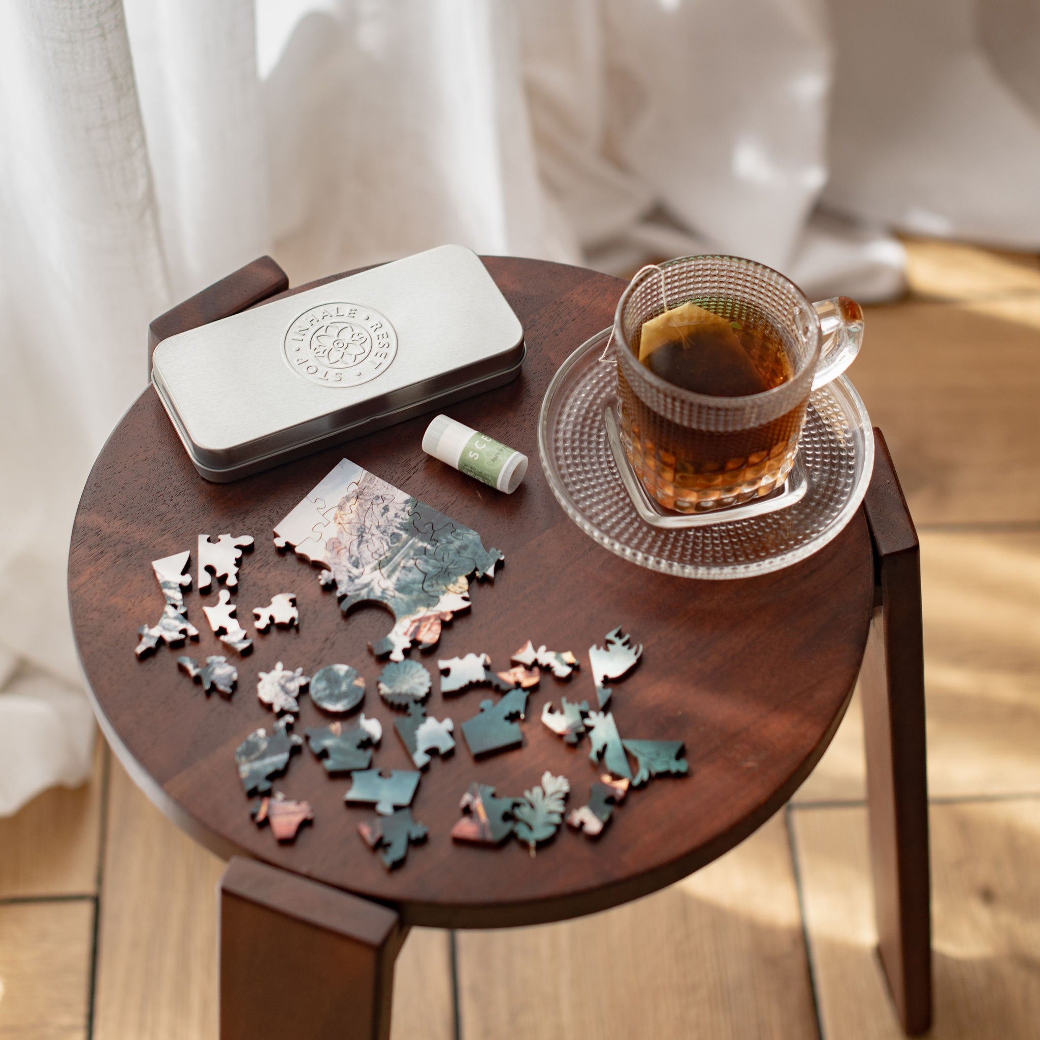 De-stress Change of Pace puzzle, balm and herbal tea on wooden table