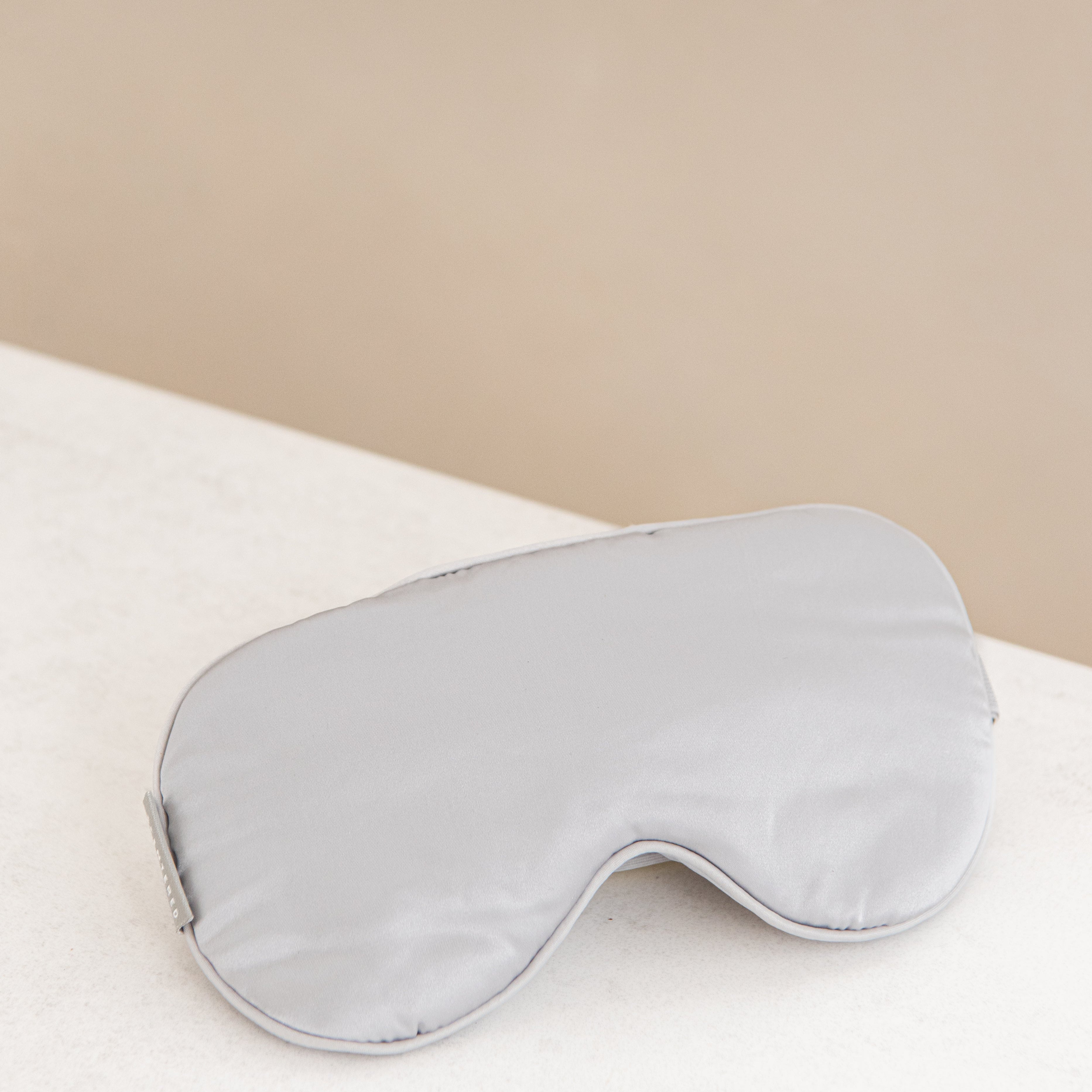 Silver sleep mask on display.