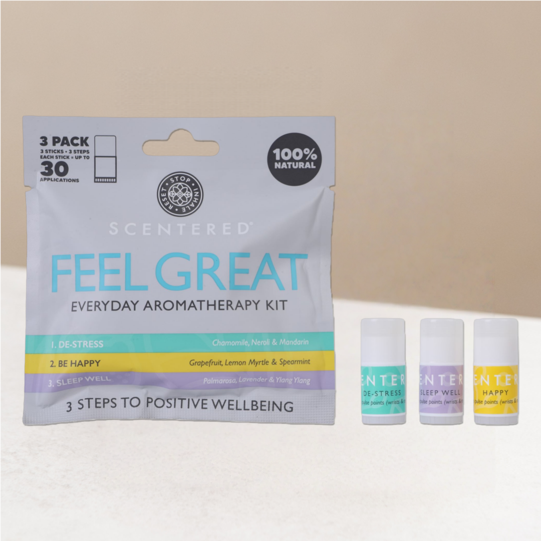 Scentered 'Feel Great' everyday aromatherapy kit with three small mini balms on warming background