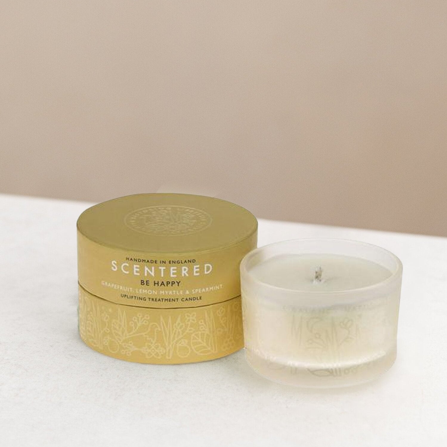 Scented happy candle and its packaging on display.