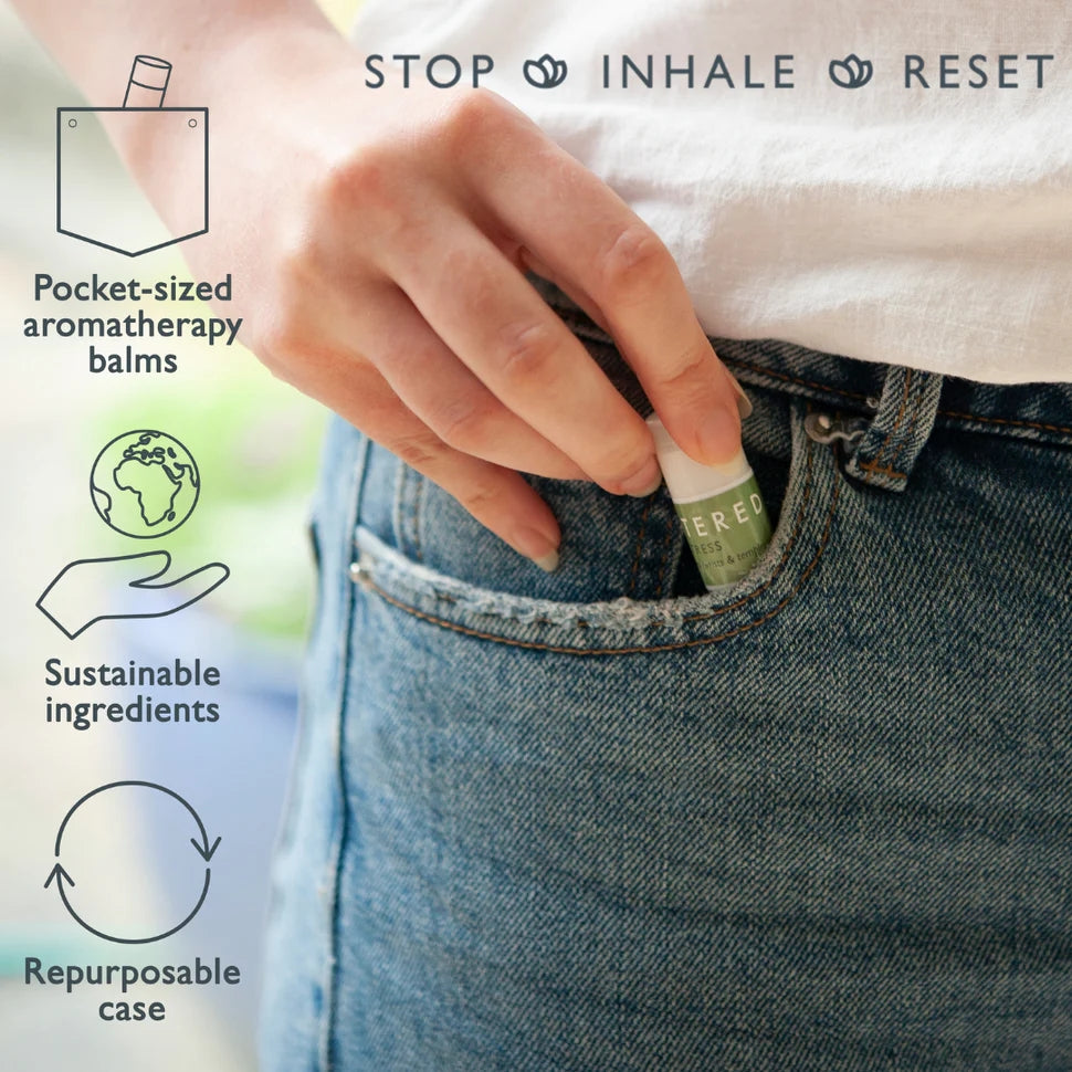 Person placing a pocket-sized aromatherapy balm in their jeans pocket with text highlighting features like sustainable ingredients and repurposable case.