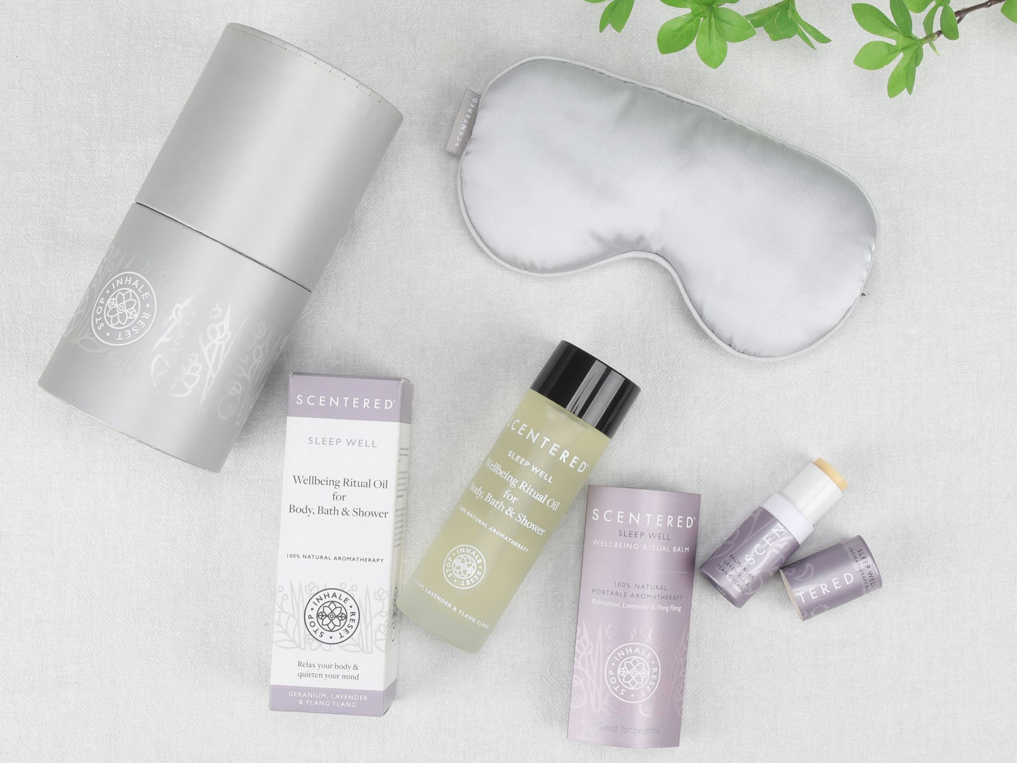 Flat lay image of Scentered body oil, Sleep Well balm and silk eye mask