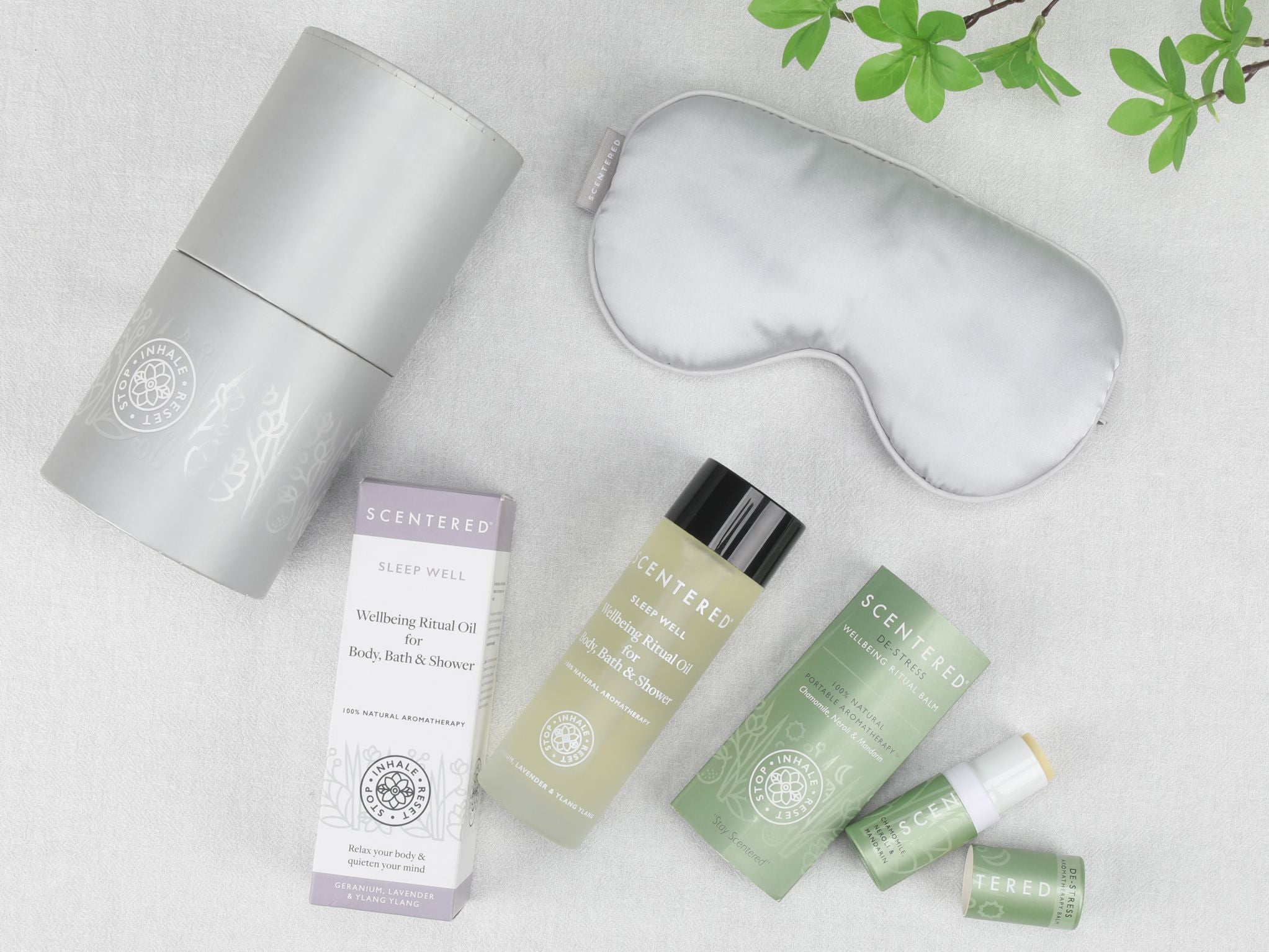 Flat lay image of Scentered  Sleep Well body oil, De-stress Aromatherapy balm and silk eye mask